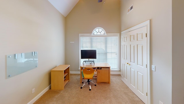 home office with light colored carpet and vaulted ceiling