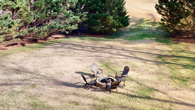 view of yard with a fire pit