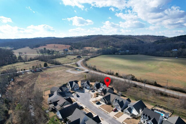 birds eye view of property with a rural view