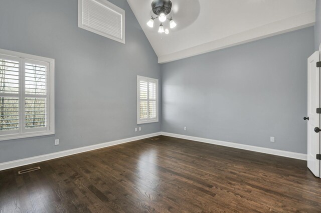 empty room featuring high vaulted ceiling, dark wood-type flooring, a wealth of natural light, and ceiling fan