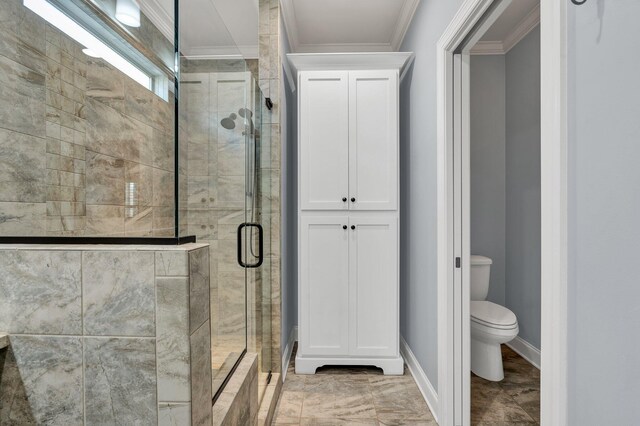 bathroom with toilet, an enclosed shower, and crown molding