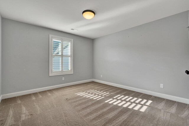 unfurnished room featuring carpet