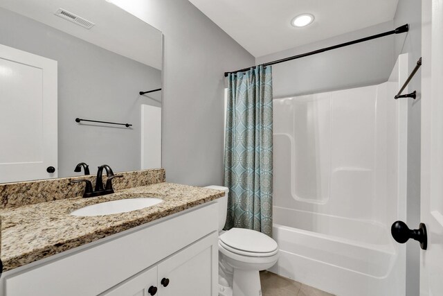 full bathroom featuring toilet, vanity, tile patterned floors, and shower / bath combo with shower curtain