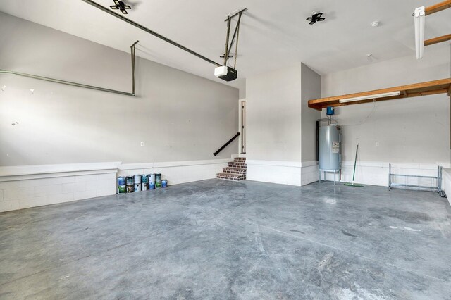 garage featuring water heater and a garage door opener