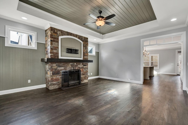 unfurnished living room featuring wooden ceiling, ornamental molding, a raised ceiling, and a fireplace