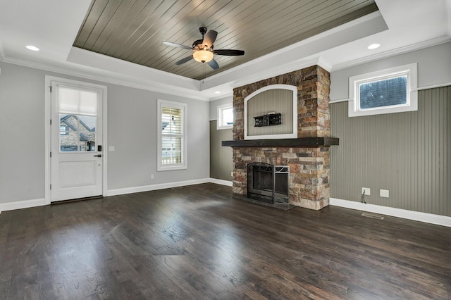 unfurnished living room with ceiling fan, a fireplace, a raised ceiling, crown molding, and wood ceiling