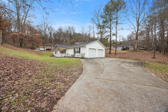 view of property exterior with a porch, a garage, and a yard