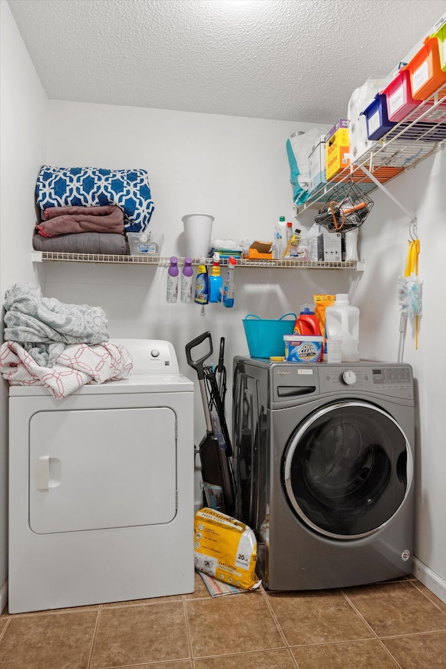 laundry area with tile patterned floors and a textured ceiling