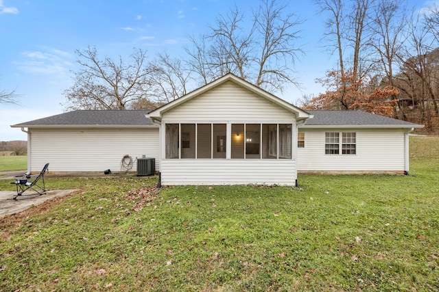 back of house featuring a lawn, central AC, and a sunroom