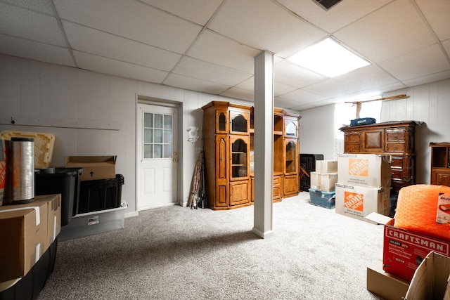 basement with carpet floors and a drop ceiling