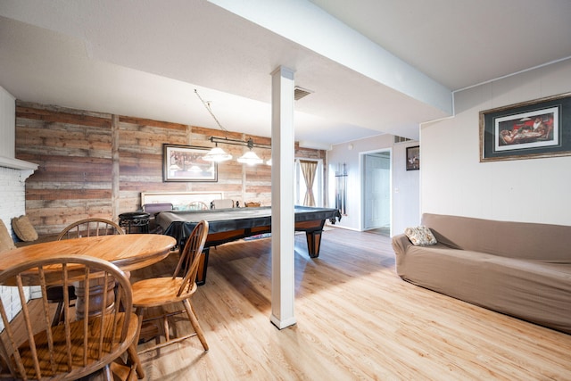 recreation room with billiards, wooden walls, and light hardwood / wood-style flooring