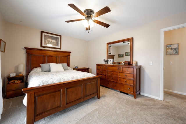 bedroom featuring light carpet and ceiling fan