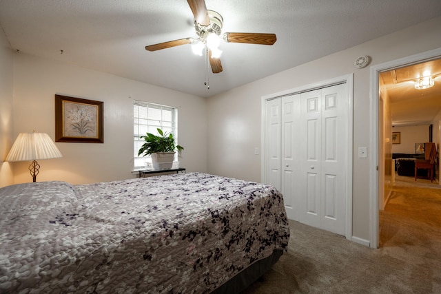 bedroom with ceiling fan, carpet floors, and a closet