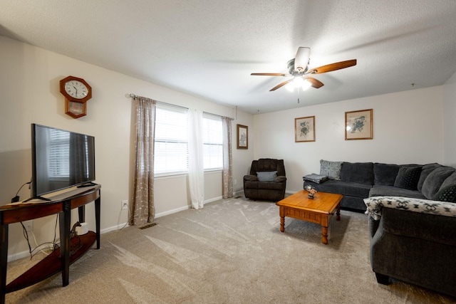 carpeted living room with ceiling fan and a textured ceiling