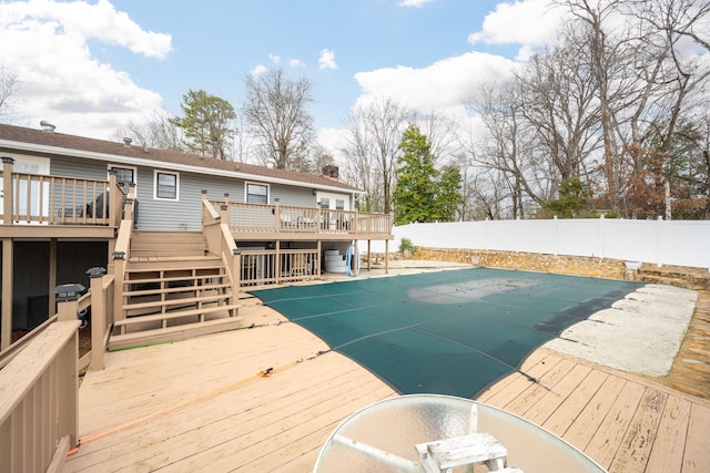 view of pool featuring a wooden deck and a patio