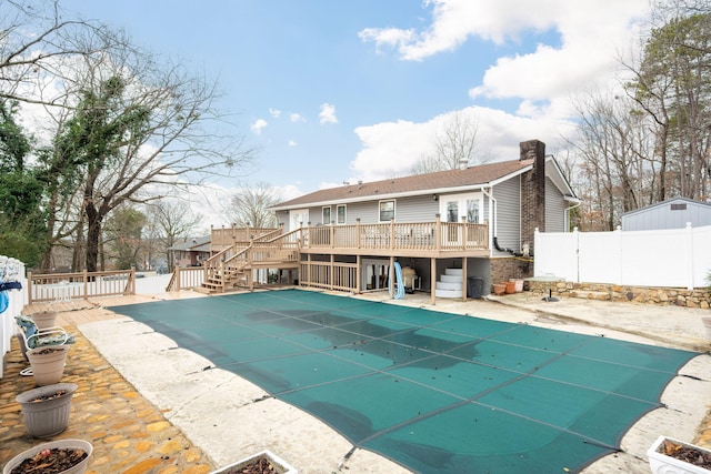 view of swimming pool featuring a deck and a patio