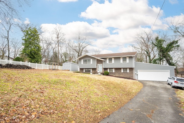 split foyer home featuring a storage unit, a garage, and a front lawn