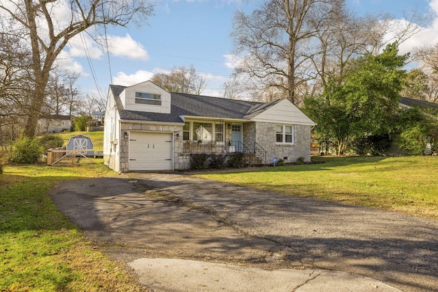 view of front of property with a front yard and a storage unit