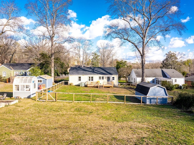 view of yard featuring an outdoor structure and a deck