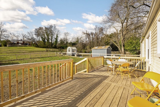 wooden terrace featuring a shed and a yard