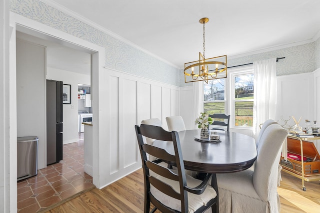 dining room with crown molding, dark wood-type flooring, and an inviting chandelier