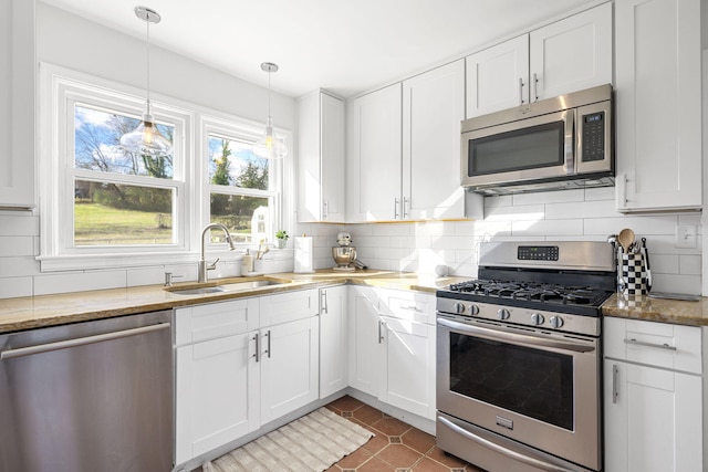 kitchen with stainless steel appliances, white cabinetry, and sink