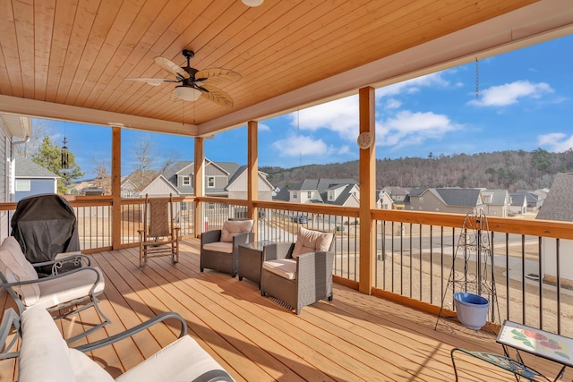 sunroom with wood ceiling and ceiling fan