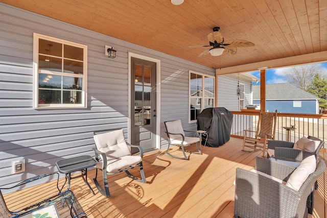 wooden terrace with a grill and ceiling fan