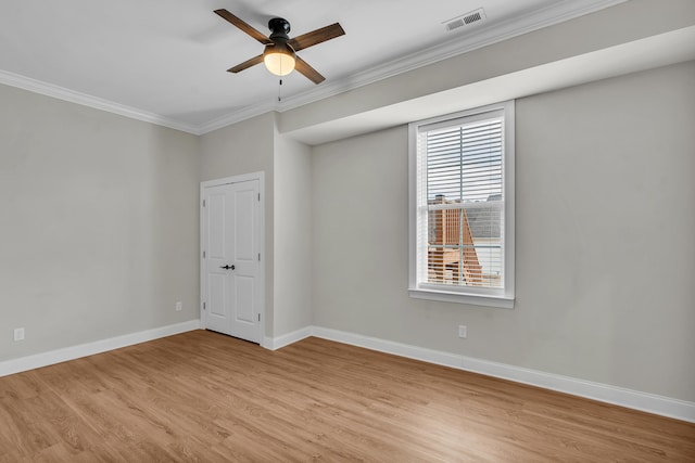 empty room with ceiling fan, ornamental molding, and light hardwood / wood-style flooring