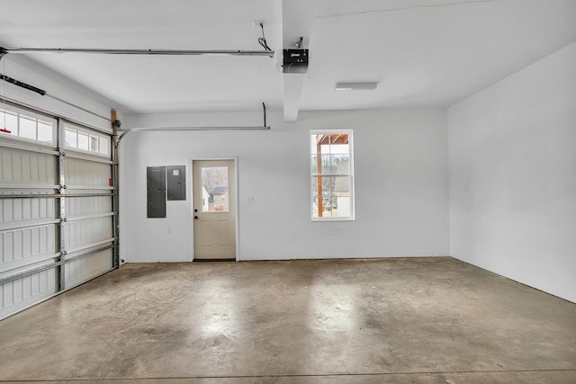 garage featuring a garage door opener and electric panel