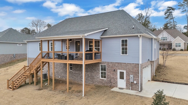 rear view of property featuring a garage and a porch