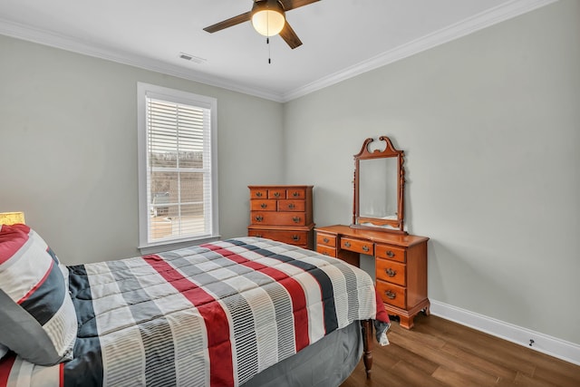 bedroom with ornamental molding, dark hardwood / wood-style floors, and ceiling fan