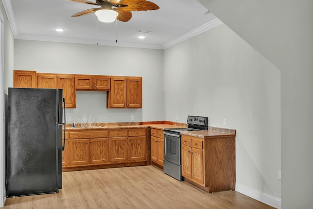 kitchen with sink, ceiling fan, black refrigerator, light hardwood / wood-style floors, and stainless steel electric range oven