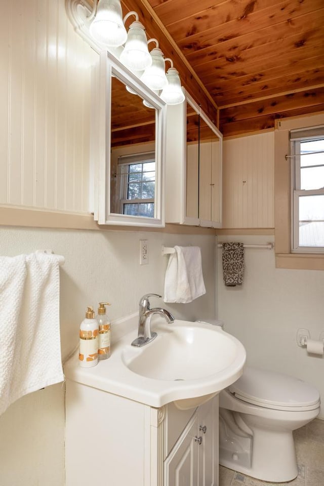 bathroom with vanity, toilet, a wealth of natural light, and wood ceiling