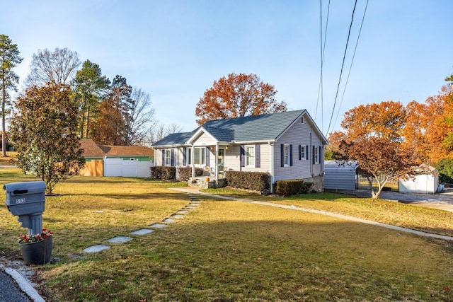 bungalow with a storage shed and a front yard