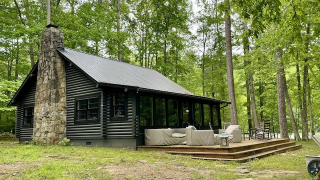 rear view of house featuring a deck