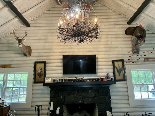 interior details featuring log walls and an inviting chandelier