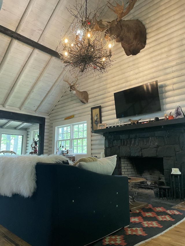 living room with rustic walls, wooden ceiling, a stone fireplace, vaulted ceiling with beams, and hardwood / wood-style floors