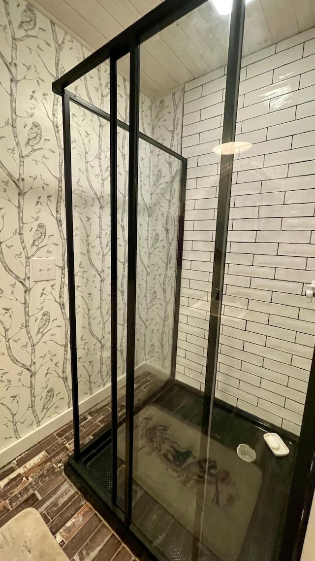 bathroom featuring hardwood / wood-style floors and a shower with shower door