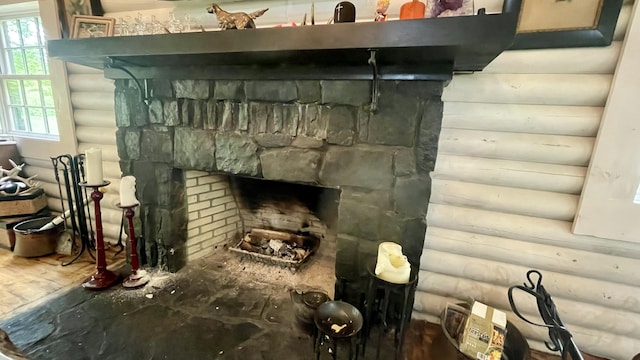 interior details with a fireplace and rustic walls