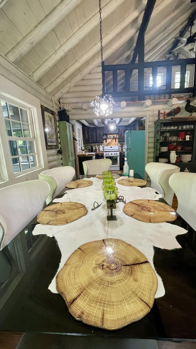 dining area with lofted ceiling with beams and wood ceiling