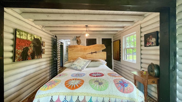 bedroom featuring beam ceiling and log walls