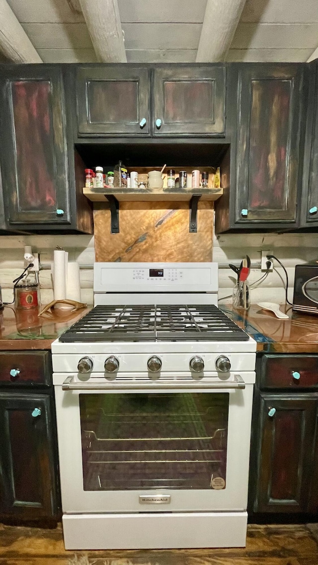 kitchen with dark brown cabinets and white gas range oven