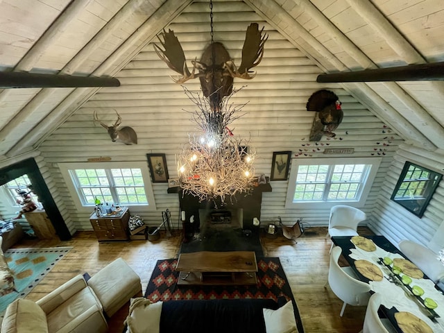 living room with hardwood / wood-style flooring, wooden ceiling, log walls, and an inviting chandelier