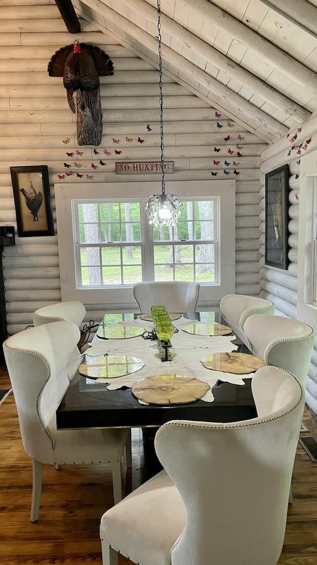 dining room with vaulted ceiling with beams, dark hardwood / wood-style floors, wooden ceiling, and rustic walls