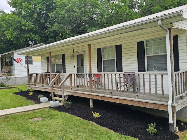 1896 Old Washington Hwy, Dayton, TN 37321 - view of front of home featuring covered porch, metal roof, and a front lawn