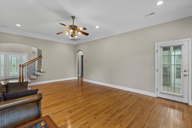 living room with ceiling fan, wood-type flooring, and ornamental molding