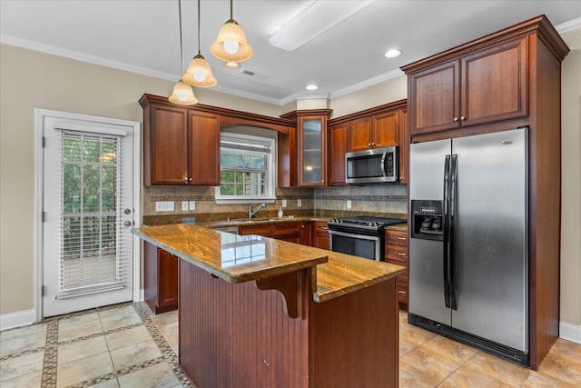 kitchen featuring pendant lighting, dark stone countertops, ornamental molding, appliances with stainless steel finishes, and tasteful backsplash