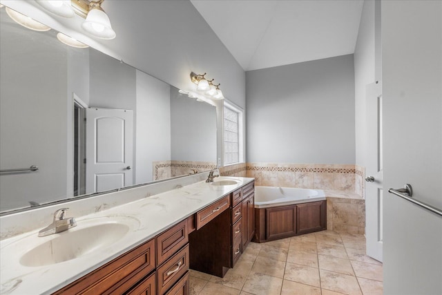 bathroom featuring tile patterned flooring, vanity, a relaxing tiled tub, and vaulted ceiling