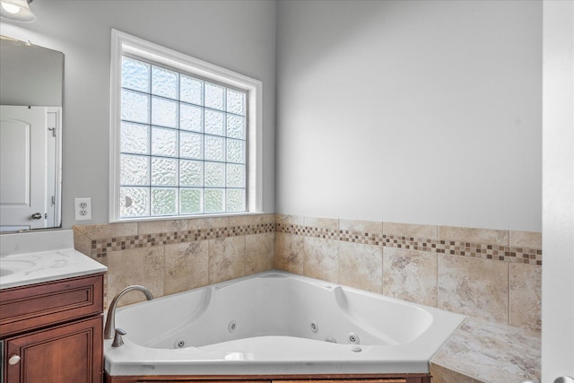 bathroom with vanity, a bath, and a wealth of natural light